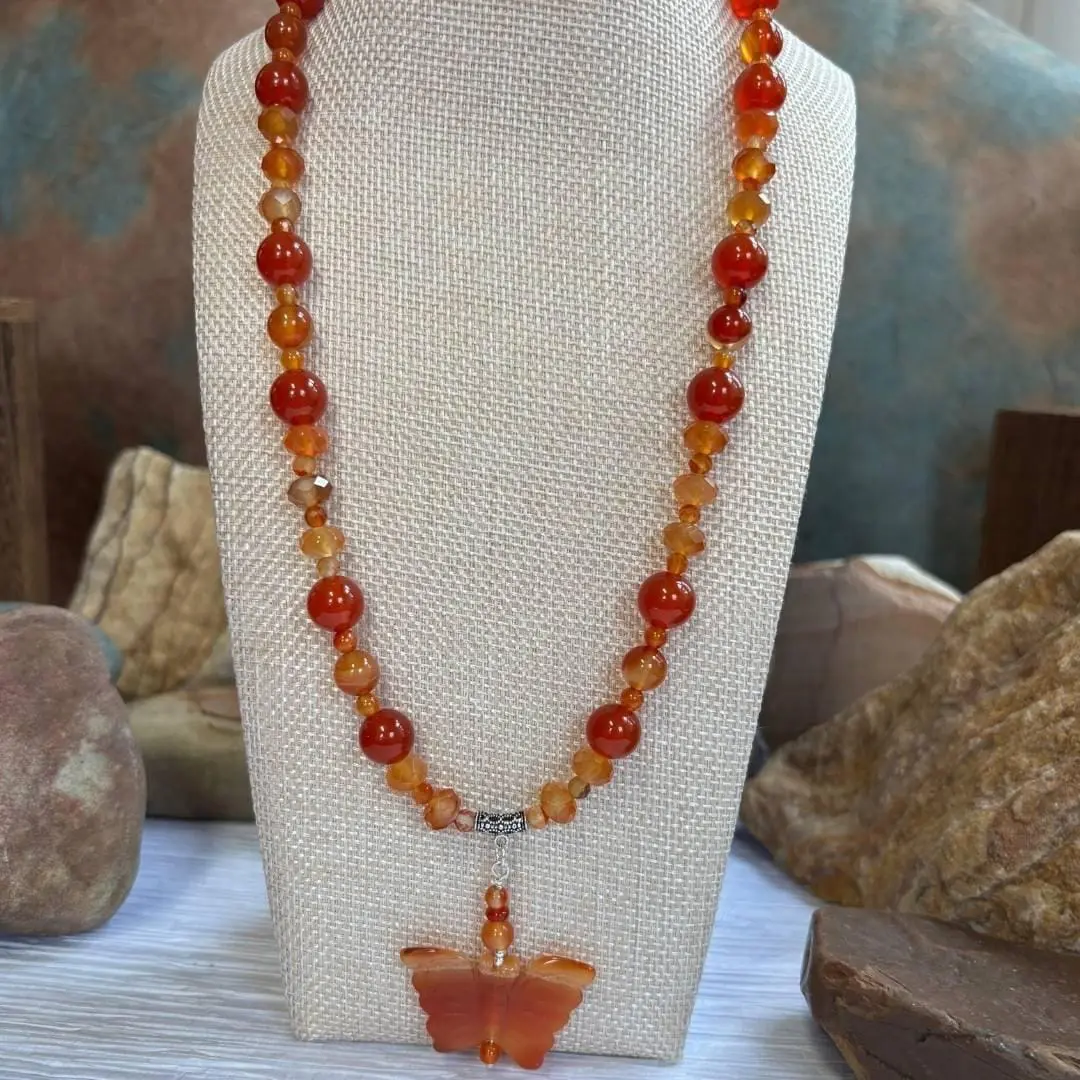 an image of a Carnelian and Sterling Silver Beaded Butterfly Necklace. It has mixed round and faceted beads with a hand carved butterfly pendant.