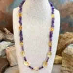 an image of a Citrine and Amethyst Beaded Necklace with citrine smooth nuggets, citrine barrel beads and 4 mm faceted amethyst and amethyst smooth nuggets. The necklace is 19.75 inches long
