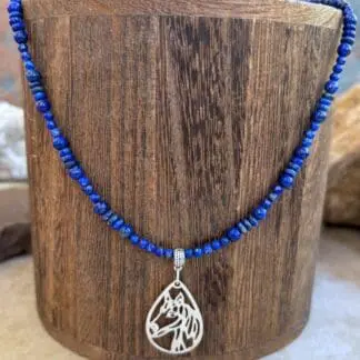 an image of a Lapis Lazuli Beaded Necklace with Horse Pendant featuring two sizes of small round smooth lapis beads with small rondelle beads. The focal point is a silhouette filigree teardrop shaped pendant of a horse's head in sterling silver.