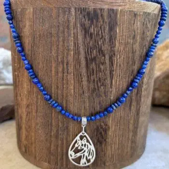 an image of a Lapis Lazuli Beaded Necklace with Horse Pendant featuring two sizes of small round smooth lapis beads with small rondelle beads. The focal point is a silhouette filigree teardrop shaped pendant of a horse's head in sterling silver.