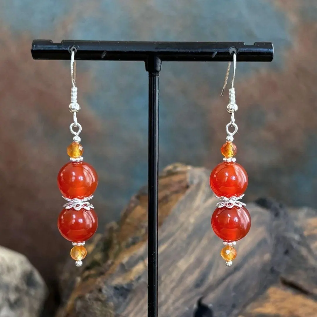 an image of a pair of Carnelian and Sterling Silver Beaded Earrings featuring 2 8mm round orange carnelian beads with 2 4mm faceted golden carnelian beads and sterling silver accents.