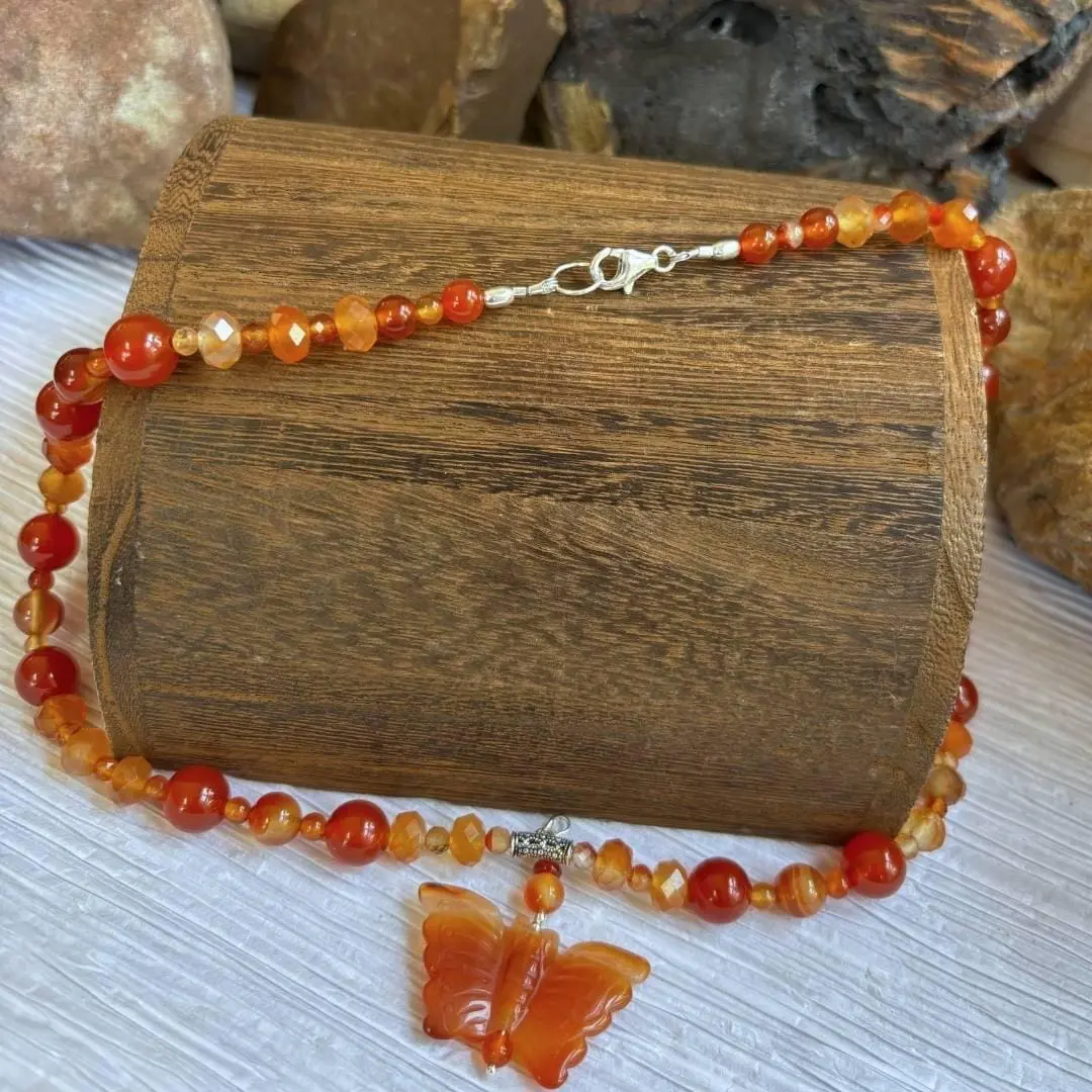 an image of a Carnelian and Sterling Silver Beaded Butterfly Necklace. It has mixed round and faceted beads with a hand carved butterfly pendant.