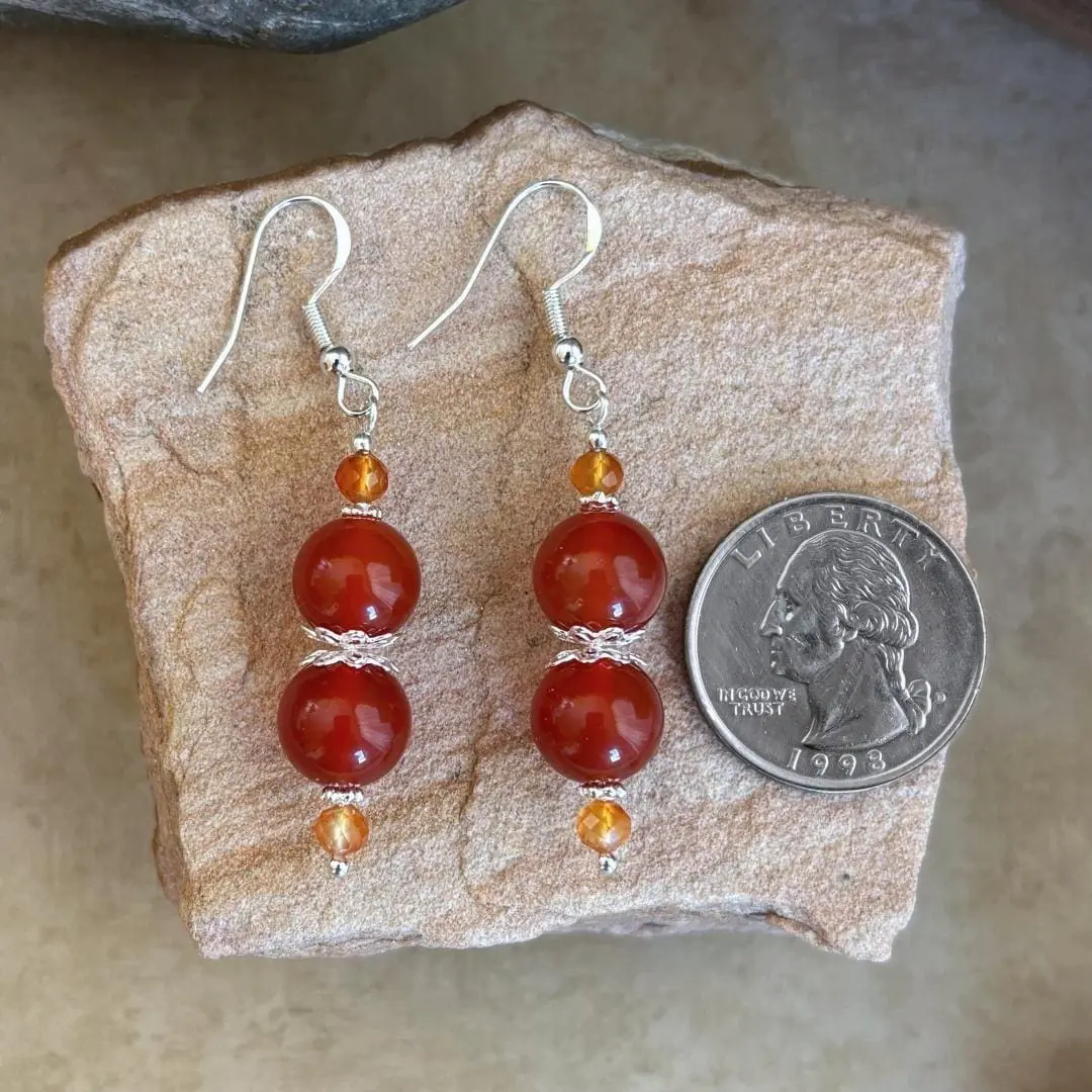 an image of a pair of Carnelian and Sterling Silver Beaded Earrings featuring 2 8mm round orange carnelian beads with 2 4mm faceted golden carnelian beads and sterling silver accents.