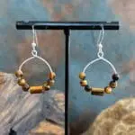 an image of a pair of Beaded Tiger's Eye and Sterling Silver Hoop Earrings hanging from a sterling silver ear hook