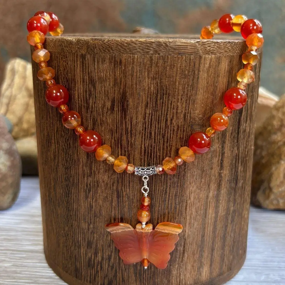 an image of a Carnelian and Sterling Silver Beaded Butterfly Necklace. It has mixed round and faceted beads with a hand carved butterfly pendant.