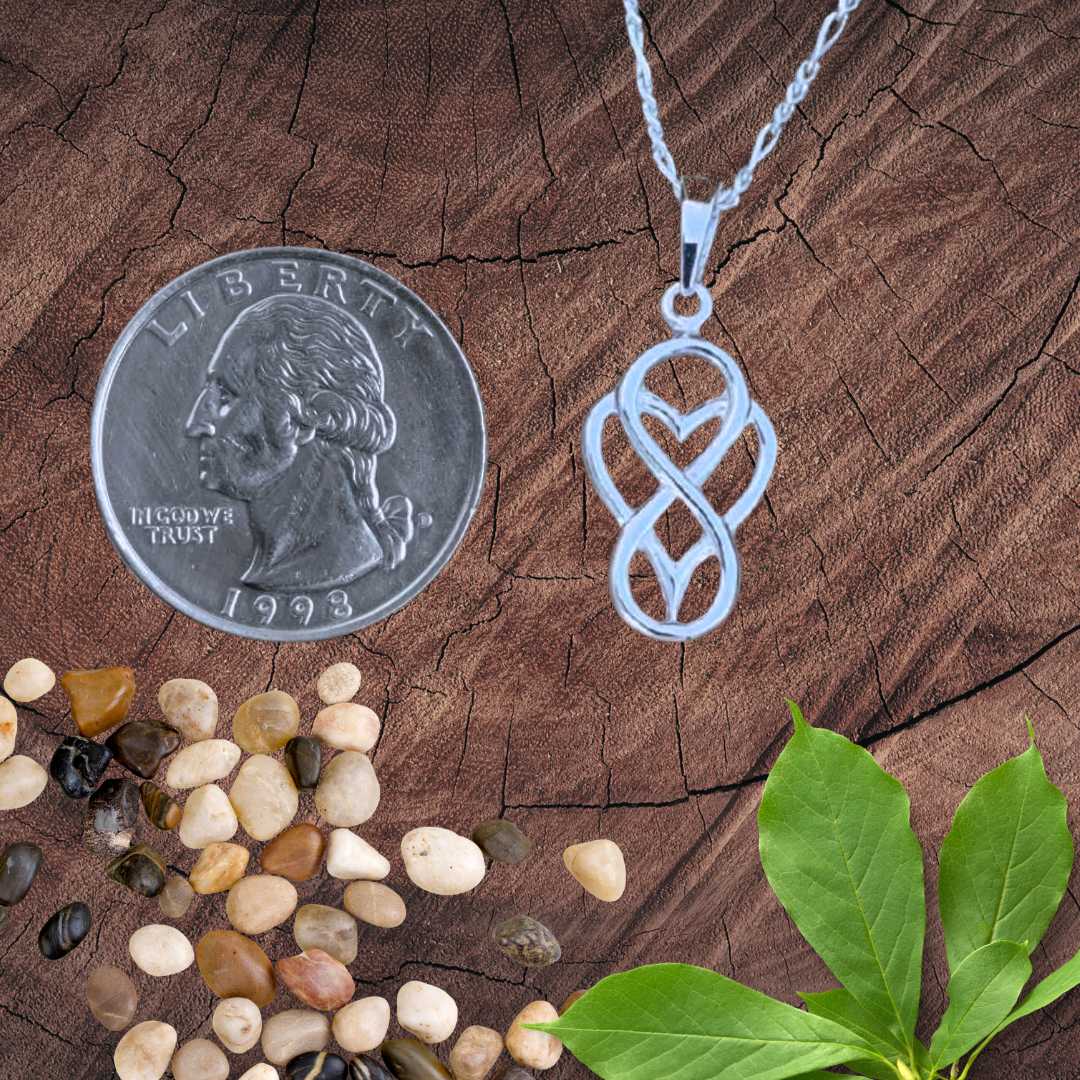 an image of an Everlasting Love Infinity Heart Sterling Silver Pendant showing an infinity symbol with a heart next to a quarter