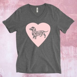 An image of a charcoal grey t-shirt with a large pink heart across the chest and a grey dachshund dog on the heart.