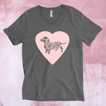 An image of a charcoal grey t-shirt with a large pink heart across the chest and a grey dachshund dog on the heart.