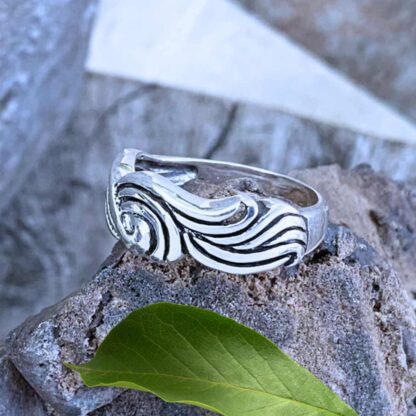 an image of a sterling silver ring with a design that looks like braided waves