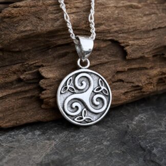 an image of a small Sterling Triskelion-Trinity Pendant. The pendant is round and in the center is the Triskele Celtic Symbol meaning three legged and in the small spaced around the Triskele symbol are three small Triquetra or Trinity Knots. There is oxidation on the background of the circle and the triskele is raised up a bit. The pendant height is .55 inches