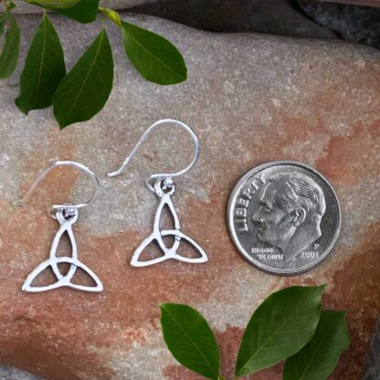 an image of a pair of dangle sterling silver Celtic Trinity Knot earrings next to a dime