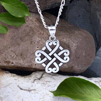Sterling Silver Celtic Four Hearts Pendant Next to Dime