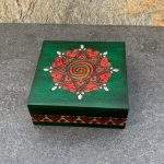 an image of a square green box with red hearts and spirals handcrafted in Poland