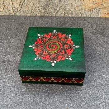 an image of a square green box with red hearts and spirals handcrafted in Poland