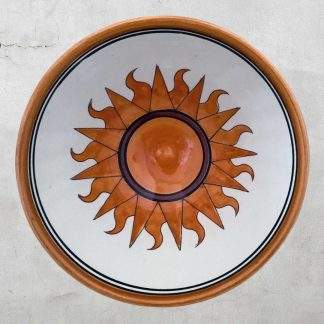 Flaming Orange Sun on White Pottery Bowl with Blue and Gold Rim