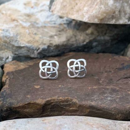 A pair of sterling silver Stud earrings with a celtic knot design.