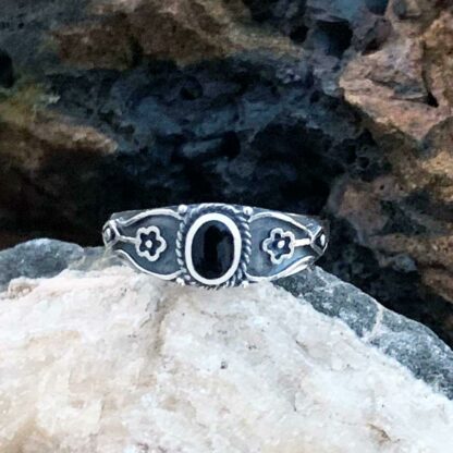 Dainty Sterling & Oval Black Agate Ring with flower on each side of stone.