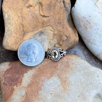 Dainty Oval Faceted Citrine and Sterling Silver Ring Next To Quarter