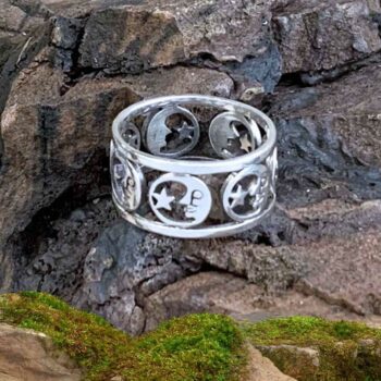 A picture of a half moon wrapping around an open area with a star inside each moon. The design is in sterling silver and repeat wraps around the band style ring several times.