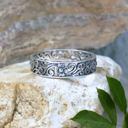 Sterling Fairy Garden Ring is a filigree sterling silver band with swirls and dainty flowers in the design that wraps around the band