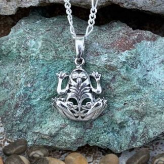 A sterling silver filigree frog pendant