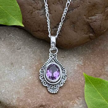 A photo of our Oxidized Sterling Silver Pendant with oval faceted amethyst gemstone in a vintage flair.
