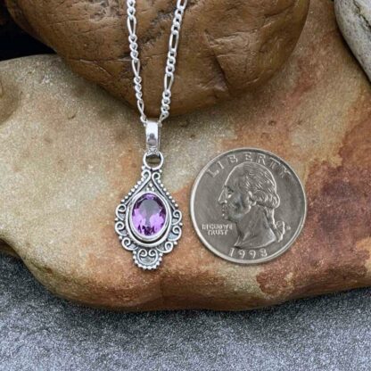 A photo of our Oxidized Sterling Silver Pendant with oval faceted amethyst gemstone in a vintage flair.