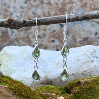 photo of Double Dangle Peridot Earrings set in sterling silver with stones faceted and cut in teardrop shape.
