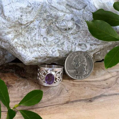 Oval Faceted Amethyst Wide Filigree Sterling Silver Ring Next to Quarter