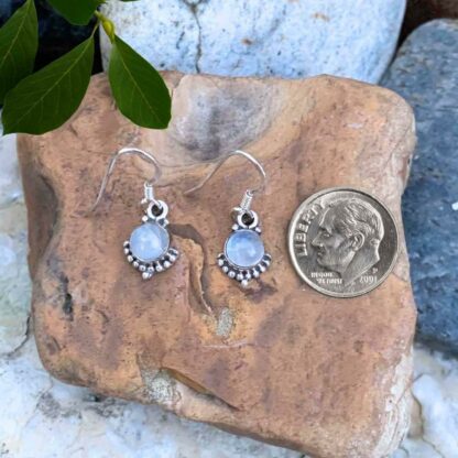 Precious Petite Round Rainbow Moonstone Earrings set in beaded Sterling Silver setting next to a dime for perspective