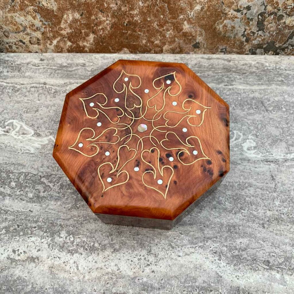 Moroccan Thuya Wood Octoganal Box with Inlaid Hearts made of brass and accent dots of mother of pearl and abalone.