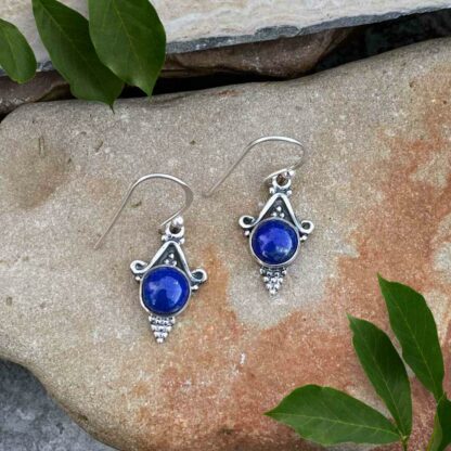 Round Lapis Lazuli Blue Gemstone in sterling silver setting with silver beads coming to a point below the stone. Sterling Fish hook style. Slight dangle.