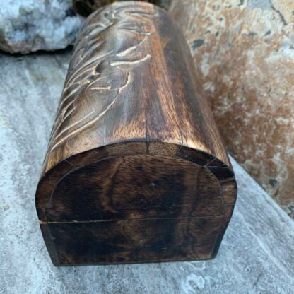 Primitive Hand Carved Mango Wood Elephant Trunk Box With 2 elephants on top and three elephants across the front. All the trunks are up. Dimensions are 9" Long x 5.25" Wide x 5.25" High. This is a side view