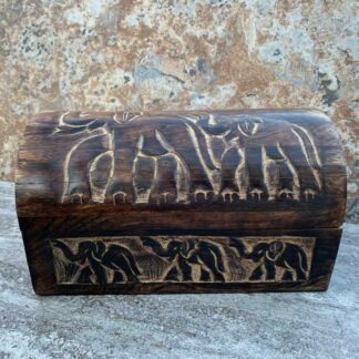 Primitive Hand Carved Mango Wood Elephant Trunk Box With 2 elephants on top and three elephants across the front. All the trunks are up. Dimensions are 9" Long x 5.25" Wide x 5.25" High.