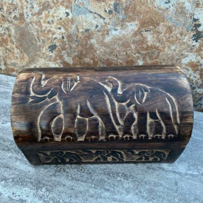 Primitive Hand Carved Mango Wood Elephant Trunk Box With 2 elephants on top and three elephants across the front. All the trunks are up. Dimensions are 9" Long x 5.25" Wide x 5.25" High.