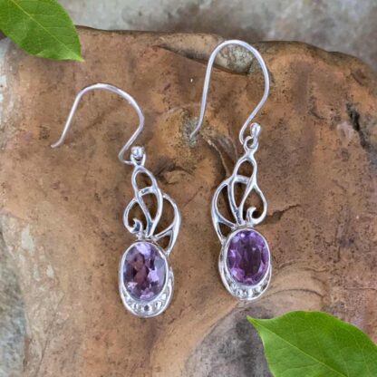 An image of our elegant Sterling Ribbons and Oval Faceted Amethyst Dangle Earrings