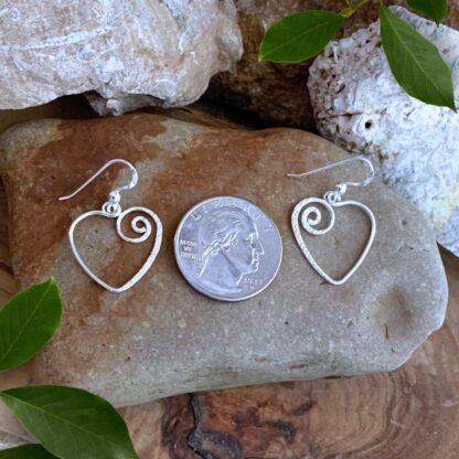 Open Sterling Silver Spiral Heart Dangle Earrings Next to a Quarter
