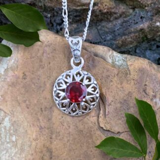 An image of a Faceted Round Garnet and Filigree Sterling Silver Pendant with an open wraparound diamond shape design in the silver.