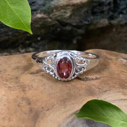 An image of our Petite Faceted Oval Garnet and Filigree Sterling Silver Ring