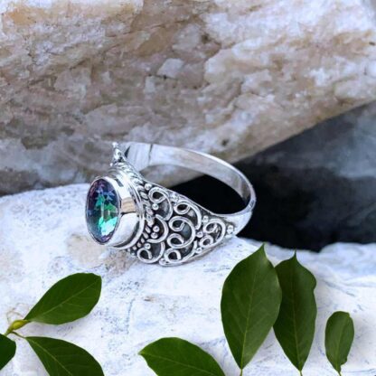 an image of the side view of an Ornate Faceted Oval Mystic Topaz and Sterling Silver Ring