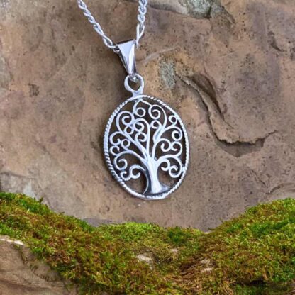 An image of a Petite Oval Sterling Silver Swirling Tree of Life Pendant with a total drop of .748 inches