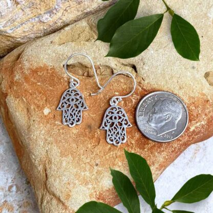 an image of a petite dangly pair of Sterling Silver Filigree Hamsa Earrings with an eye in the center of the palm section of the hand