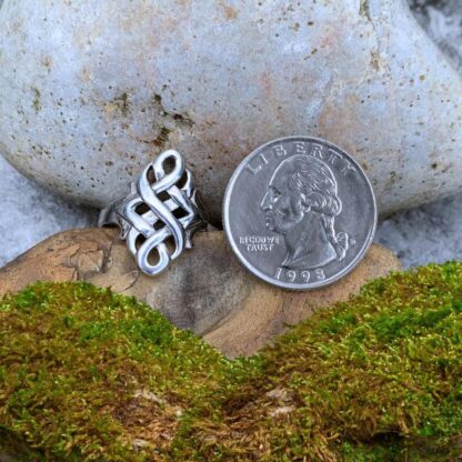 An image of our Sterling Silver Celtic Knot Marquise Ring next to a quarter