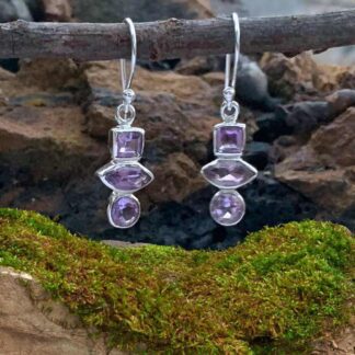 an image of a pair of Triple Amethyst and Sterling Silver Dangle Earrings with the top amethyst being square, the middle in a marquise shape and the bottom one is round.