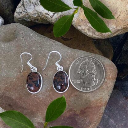 an image of a simple pair of Oval Mahogany Obsidian and Sterling Silver Earrings next to a quarter