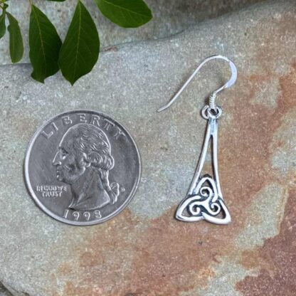 an image of a pair of dangling Triskelion and Triquetra Sterling Earrings with a Triskele symbol sitting inside a Triquetra symbol