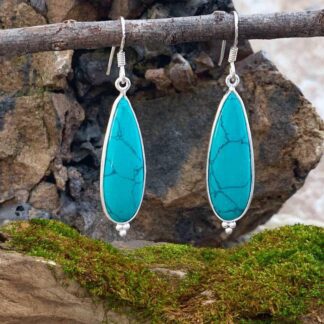 an image of a pair of Sterling Silver and Turquoise Teardrop dangling Earrings with a trio of sterling silver beads at the bottom