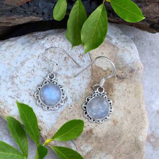 an image of a pair of Round Rainbow Moonstone and Sterling Silver Earrings. The round stone has a sterling silver scallop design surrounding it.
