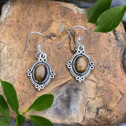 an image of a pair of Oval Tiger's Eye and Sterling Silver Earrings. Dimensions are Total Drop: 1.18 inches x Width: .51 inches