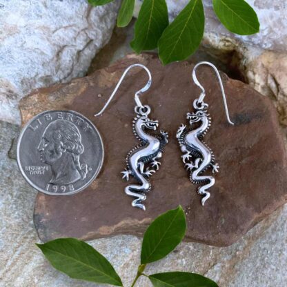 an image of a pair of Sterling Silver Dragon dangle Earrings next to a quarter